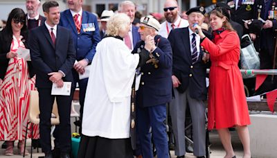 Veterans sing and dance at close of town commemoration service in Normandy