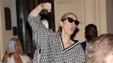 Celine Dion looks in high spirits as she plays air guitar in Paris