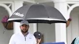 Scottie Scheffler (L) and caddie Ted Scott walk to the driving range on Friday after his arrest and release before round two of the PGA Championship