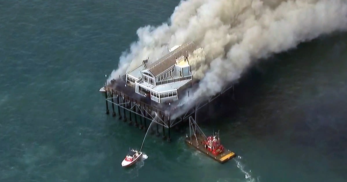 Building at end of Southern California pier catches fire, sending smoke billowing onto beach