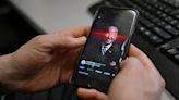...Joe Biden's X account on their phone at the White House on Feb. 12, 2024, in Washington, DC. US President Joe Biden's debut on TikTok has caused a stir...