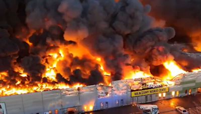 Watch as mystery blaze tears through shopping mall & destroys complex