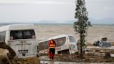 A dozen people are missing and one is dead after a landslide swept cars and buildings into the sea on an Italian coast