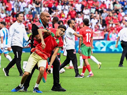 Fans storm pitch and throw bottles as Argentina v Morocco descends into chaos to kick off Olympics