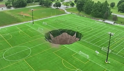 100-foot sinkhole swallows soccer fields, light pole