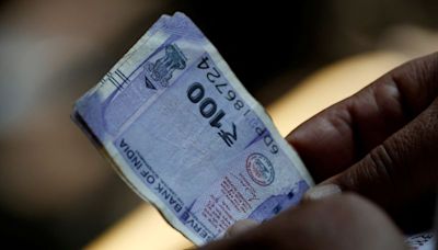 Rupee slips to record low as equity sentiment sours after tax hike