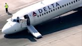 Delta passengers exit flight using jet slide after plane lands without front gear extended