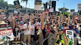 Tom Morello breaks out the Takamine and joins the Hollywood picket line as he plays Woody Guthrie for striking union members