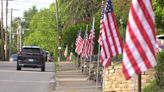 Volunteers hang flags in Westmoreland County to honor fallen police chief Justin McIntire