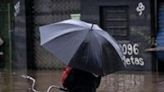 A local attempts to ride a bike in a flooded street at Santos Dumont neighbourhood in Sao Leopoldo, Rio Grande do Sul, Brazil, on May 12, 2024