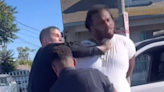 Shocking moment LAPD cop punches a man in the face while his hands are cuffed