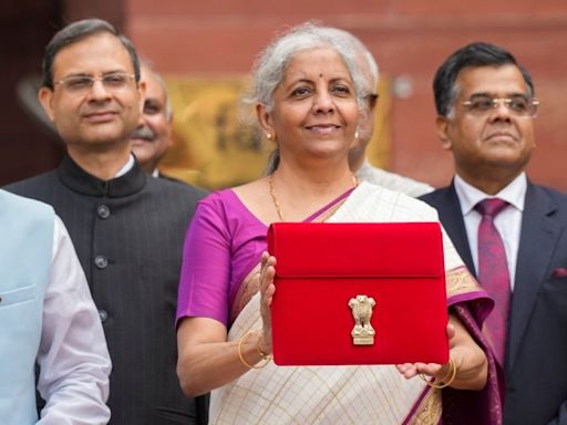 Budget 2024: FM Nirmala Sitharaman, Draped in White & Magenta Silk Saree, Poses With Tablet in Red Sleeve - News18