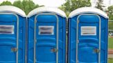 Man tips over port-a-potty with woman, child inside during argument, police say