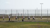 Color-coded migrants wait for answers in Texas heat