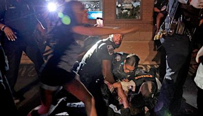 Protests turn turbulent at Ferguson police station on anniversary of Michael Brown’s death