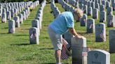 Volunteers place flags on veterans' headstones, 'honoring the people who died for us'
