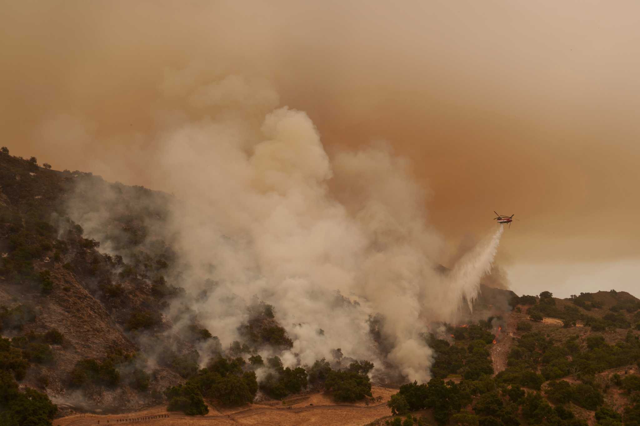 Torrid heat bakes millions of people in large swaths of US, setting records and fanning wildfires