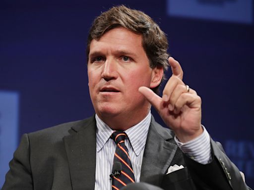 Tucker Carlson appears to laugh as protestor confronts him on Ukraine