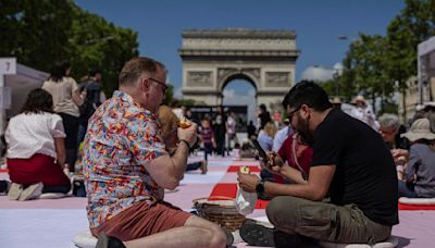 Paris' famous Champs-Elysees turned into a mass picnic blanket for an unusual meal