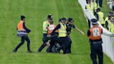 Epsom Derby: Protester tackled to ground after running onto race track