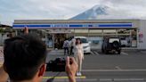 Japanese town overrun with tourists puts up view-blocking barrier near Mount Fuji