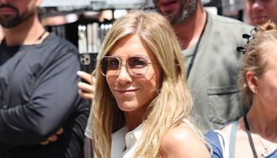 Jennifer Aniston makes heads turn in a low-cut blouse and linen pants