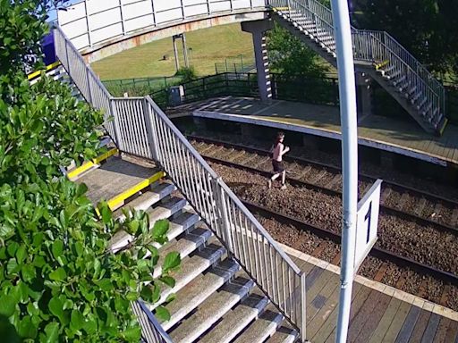 Moment moronic youngster runs over live train tracks at Newton Aycliffe station