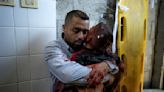 A boy in Gaza was killed by an Israeli airstrike. His father held him and wouldn't let go