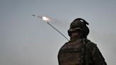 A member of company tactical group "Steppe Wolves" of the Voluntary Formation of the Zaporizhzhia Territorial Community fires a handmade small multiple rocket launch system toward Russian troops near a front line