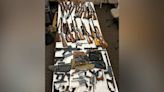 Dozens of firearms found in East County home; 2 suspects arrested