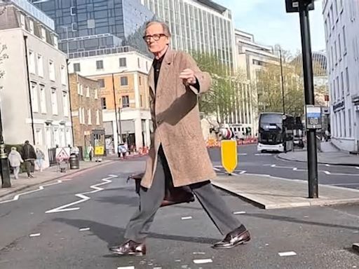 Love actually! Moment stunned cyclist is thanked by Bill Nighy after stopping at red light as Hollywood star crossed the road in London