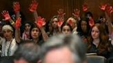 Pro-Palestinian demonstrators hold up painted hands in protest as US Secretary of State Antony Blinken testifies before a Senate Appropriations subcommittee