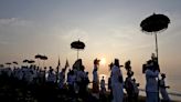 AP PHOTOS: Balinese celebrate New Year with firefights, sword-piercing and a sacred Day of Silence