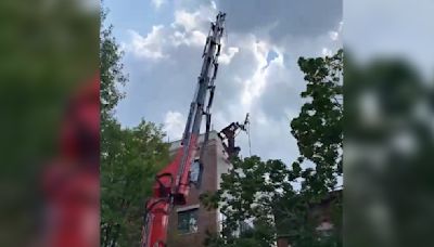 Part of a crane falls onto roof of four-story building in Borough Park