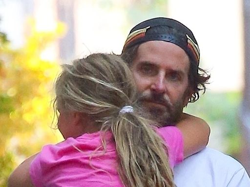 Bradley Cooper carries daughter Lea in his arms during stroll in NYC