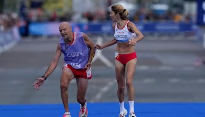 Paralympics marathon runner stripped of medal after helping guide with cramp metres from finish