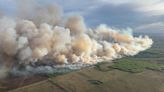 Explosive wildfire threatens to overrun Canadian town as US gets season’s first dose of smoke