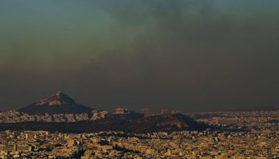 Crews battle scattered fires in Athens suburbs, helped by calmer winds and reinforcements