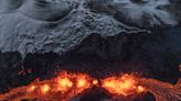 AP PHOTOS: Rivers and fountains of red-gold volcanic lava light up the dark skies in Icelandic town