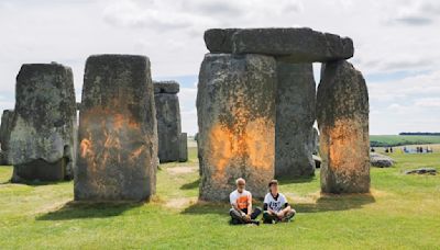 Climate protesters arrested after Stonehenge monument painted orange