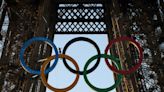 Paris Olympics organizers unveil a display of the five Olympic rings mounted on the Eiffel Tower