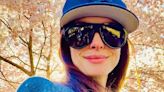 Anne Hathaway reps her star sign in a Scorpio baseball cap and bug-eye sunnies