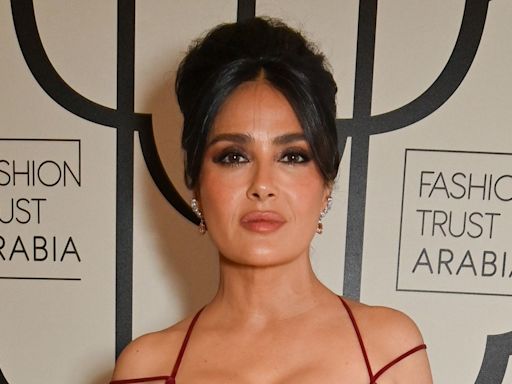 Salma Hayek's curvaceous figure looks phenomenal in extremely tight red dress