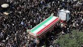 Ali Khamenei leads prayers at Ebrahim Raisi's funeral as thousands of Iranian mourners fill Tehran's streets