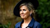 Queen Máxima's navy dress and matching hat bring 1950's elegance to somber event commemorating the abolition of slavery in the Netherlands