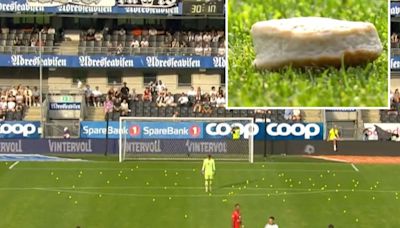 Top game abandoned with flares, tennis balls and FISH CAKES thrown on pitch