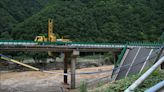 11 dead and dozens missing after a highway bridge in China crumbles in flooding and heavy storms