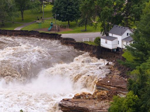 Part of a Minnesota home has plunged into the Blue Earth River as deadly Midwest flooding threatens the nearby Rapidan Dam