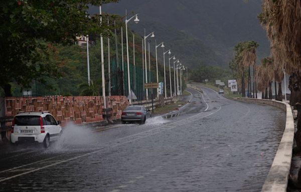 Tropical Storm Ernesto nears hurricane strength as it skirts Puerto Rico, bringing concerns of floods and power outages