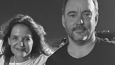 Katie Holmes looks happy as she poses with Dave Matthews